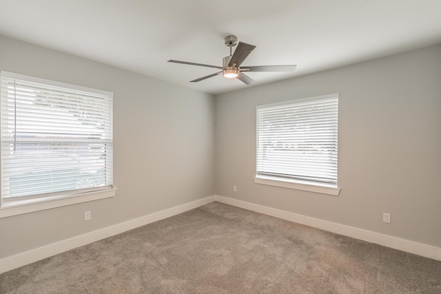 spare room with ceiling fan and carpet floors