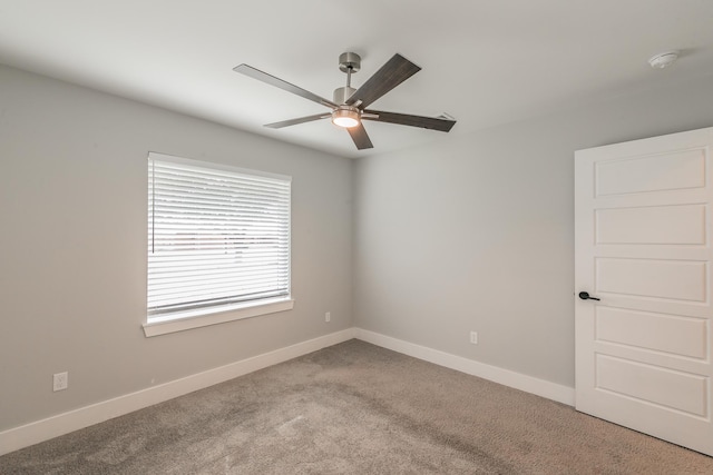 spare room with ceiling fan and carpet flooring