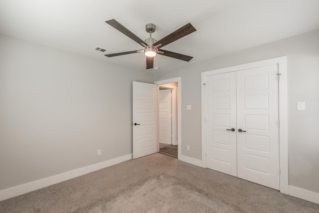 unfurnished bedroom with carpet flooring, a closet, and ceiling fan