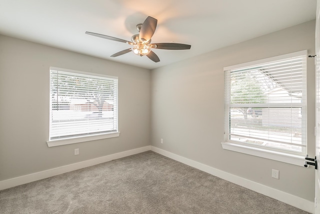 empty room featuring light colored carpet and ceiling fan