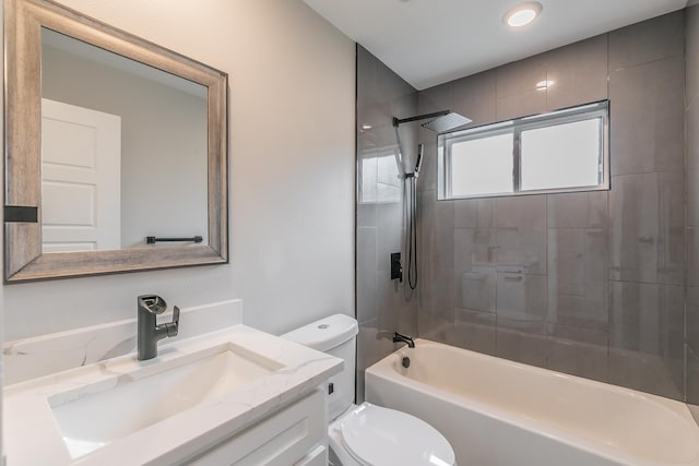 full bathroom featuring vanity, toilet, and tiled shower / bath