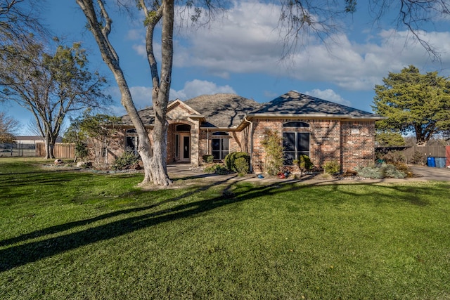 rear view of property featuring a lawn