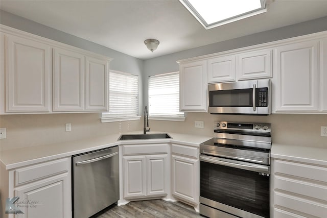 kitchen featuring sink, white cabinets, and stainless steel appliances