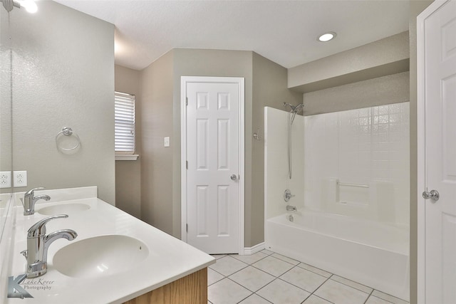 bathroom with tile patterned floors, vanity, and shower / washtub combination