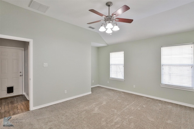 carpeted empty room featuring ceiling fan and vaulted ceiling