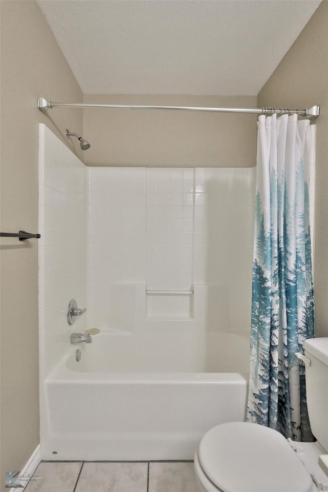 bathroom featuring shower / bath combo with shower curtain, toilet, and tile patterned flooring