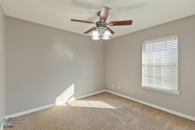 carpeted spare room with ceiling fan