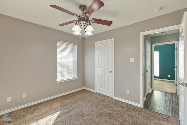 unfurnished bedroom featuring ceiling fan and carpet flooring