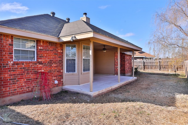 rear view of property with a patio area and ceiling fan