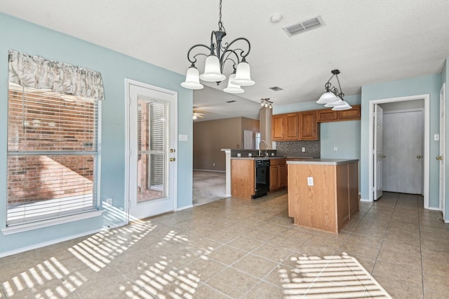 kitchen featuring tasteful backsplash, a kitchen island, black dishwasher, and decorative light fixtures