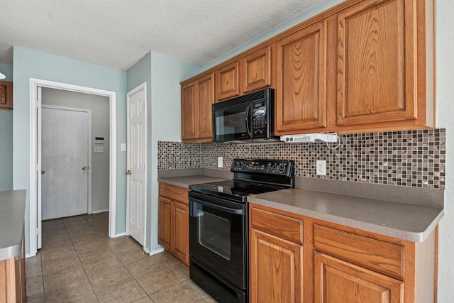 kitchen with decorative backsplash, black appliances, a textured ceiling, and light tile patterned flooring