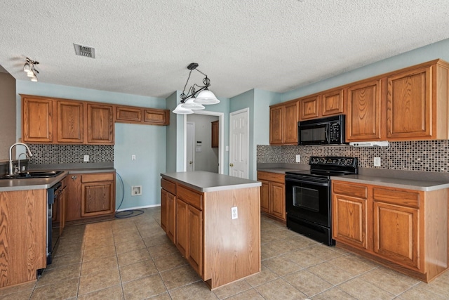 kitchen featuring a kitchen island, sink, backsplash, hanging light fixtures, and black appliances