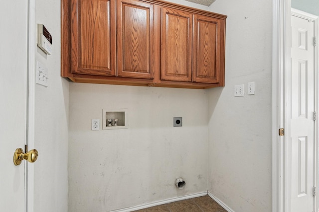 clothes washing area featuring electric dryer hookup, washer hookup, and cabinets