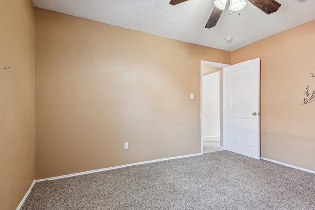 carpeted empty room with a textured ceiling and ceiling fan