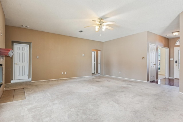 carpeted spare room featuring a textured ceiling and ceiling fan