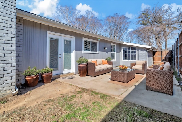 rear view of property featuring an outdoor living space, a patio area, and french doors