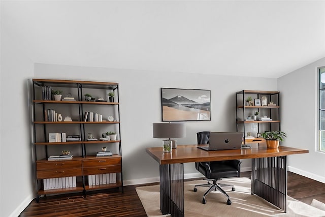 home office with dark wood-type flooring and lofted ceiling