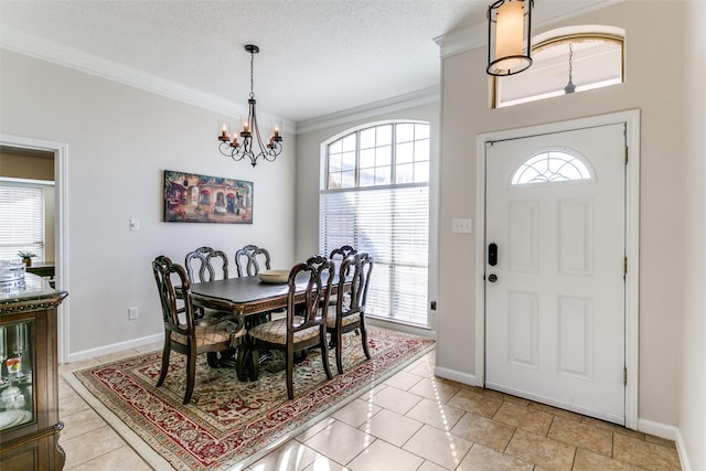 dining room featuring a textured ceiling, light tile patterned floors, crown molding, and a chandelier