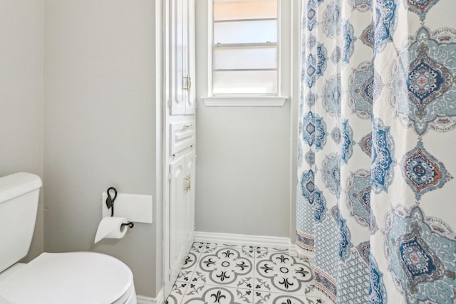 bathroom featuring toilet and tile patterned floors