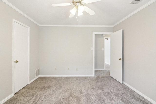 spare room featuring ornamental molding, ceiling fan, and light colored carpet