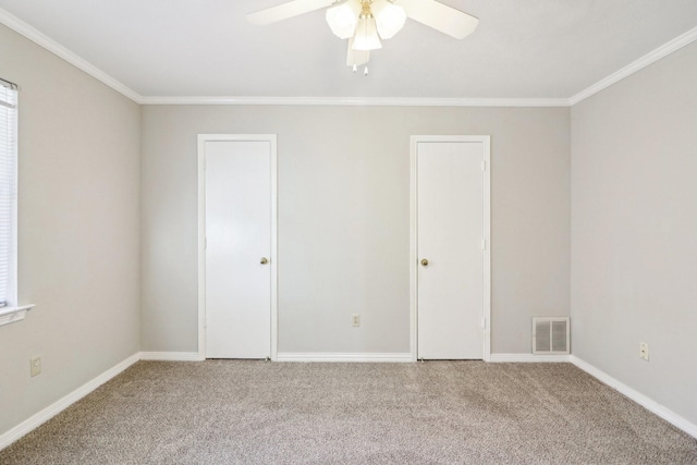 carpeted empty room featuring crown molding and ceiling fan