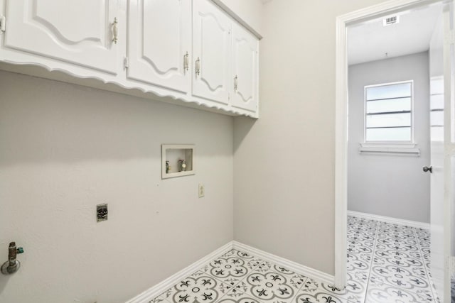 clothes washing area with washer hookup, hookup for an electric dryer, and cabinets