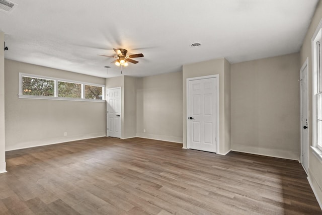 empty room featuring ceiling fan and hardwood / wood-style floors