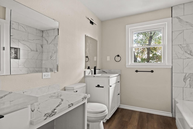 bathroom featuring hardwood / wood-style flooring, toilet, and vanity