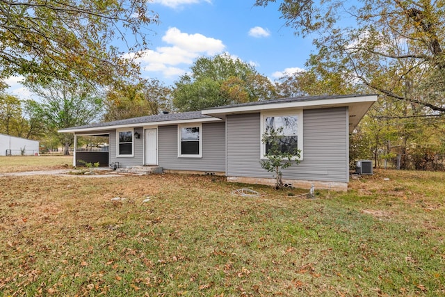 view of front of house featuring cooling unit and a front lawn