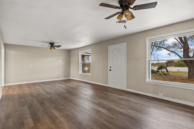 unfurnished living room with ceiling fan and dark hardwood / wood-style flooring