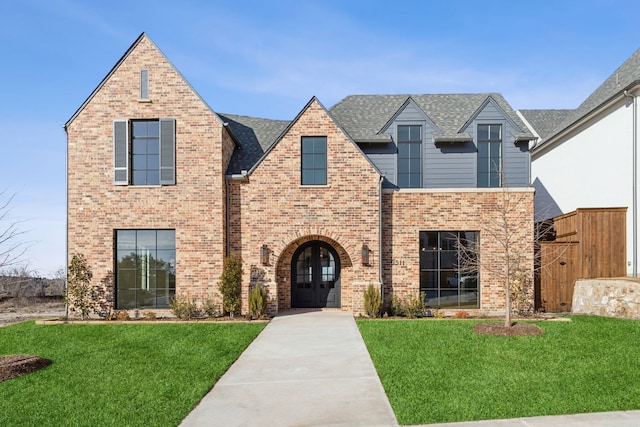 view of front of property featuring a front lawn and french doors