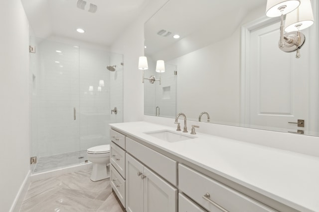 bathroom with toilet, a shower with shower door, and vanity