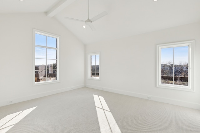 carpeted spare room featuring a healthy amount of sunlight, lofted ceiling with beams, and ceiling fan