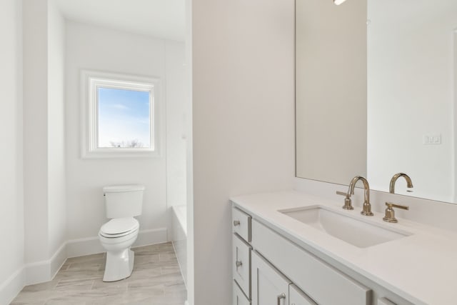 bathroom featuring vanity, toilet, and a bathing tub