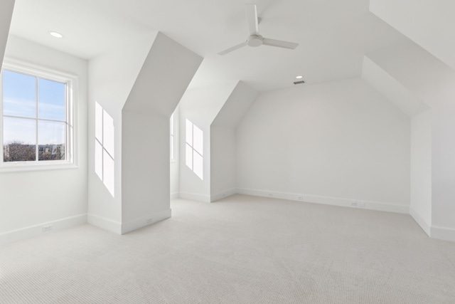 bonus room with ceiling fan, light carpet, and vaulted ceiling