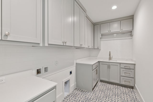 laundry area with cabinets, hookup for a gas dryer, electric dryer hookup, sink, and washer hookup