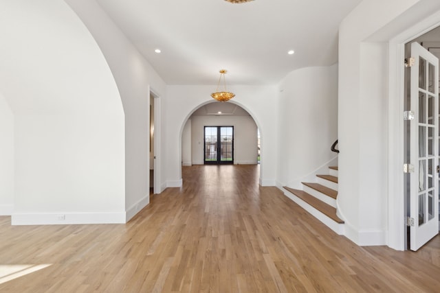 entryway featuring light hardwood / wood-style flooring and french doors