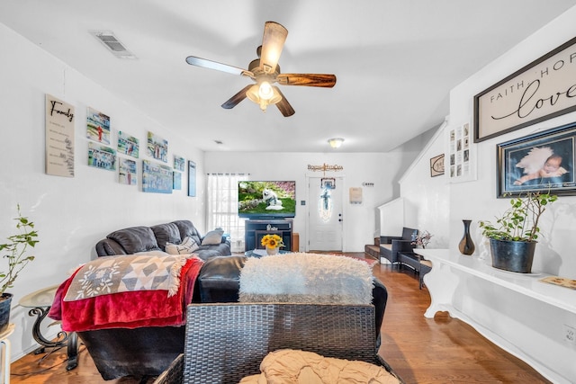 living room featuring ceiling fan and hardwood / wood-style floors