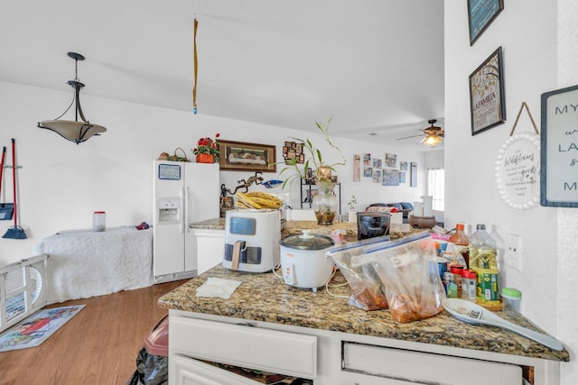 kitchen featuring decorative light fixtures, wood-type flooring, white refrigerator with ice dispenser, stone countertops, and ceiling fan