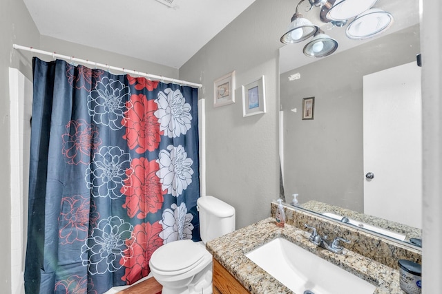 bathroom with a shower with curtain, toilet, and vanity