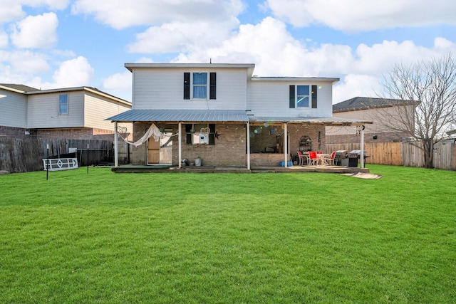 back of property with a patio area and a yard