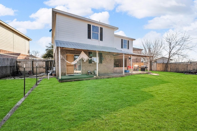 back of house with a yard and a patio