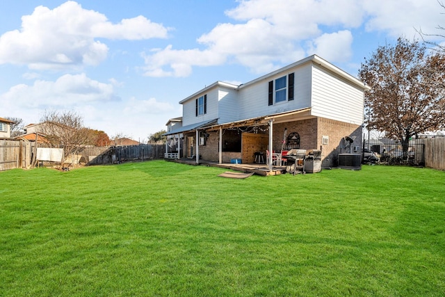 back of house with a yard and central AC