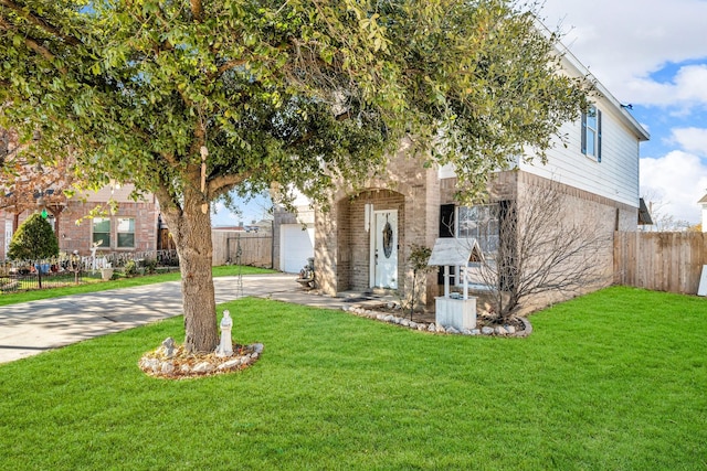 view of property hidden behind natural elements with a garage and a front lawn