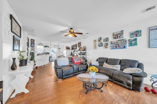 living room featuring ceiling fan and wood-type flooring