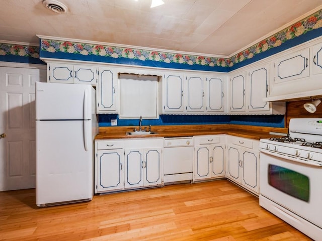 kitchen with sink, white appliances, butcher block counters, and light wood-type flooring