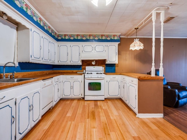 kitchen featuring pendant lighting, sink, white appliances, and white cabinets