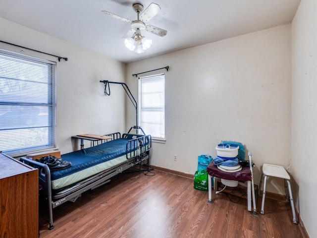 bedroom with ceiling fan and hardwood / wood-style floors