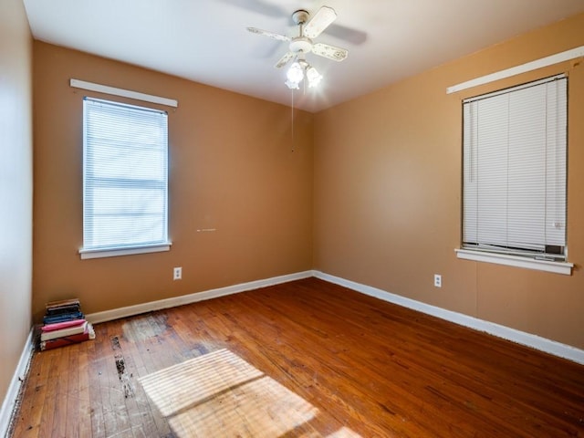 empty room with ceiling fan and hardwood / wood-style floors