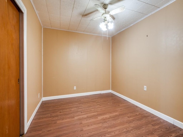 unfurnished room featuring ceiling fan, hardwood / wood-style floors, and ornamental molding